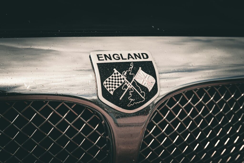 Classic British car radiator badge with Union Jack and chequered flags