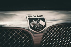 Classic British car radiator badge with Union Jack and chequered flags